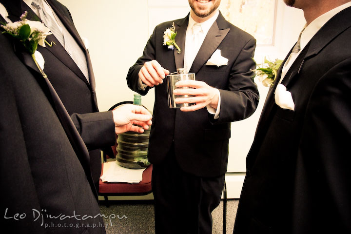 Groom, best man, and groomsmen having a drink before the ceremony. Kitty Knight House Georgetown Chestertown MD Wedding Photographer