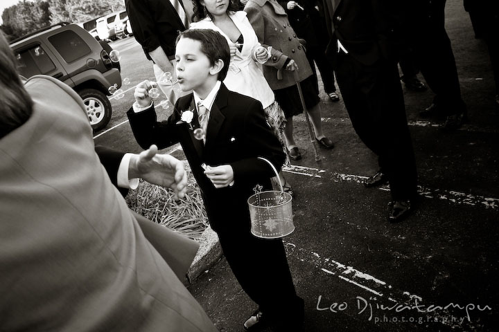 Boy blowing bubble to bride and groom at Hope Fellowship Church. Kitty Knight House Georgetown Chestertown MD Wedding Photographer