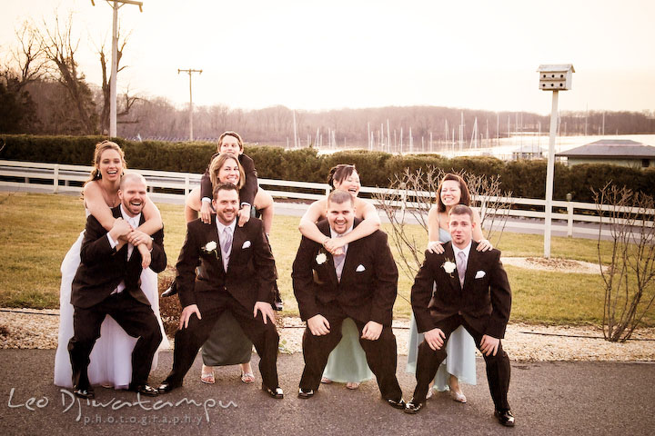 Bride, groom, best man, maid of honor, groomsmen, and bridesmaids having fun posing. Kitty Knight House Georgetown Chestertown MD Wedding Photographer