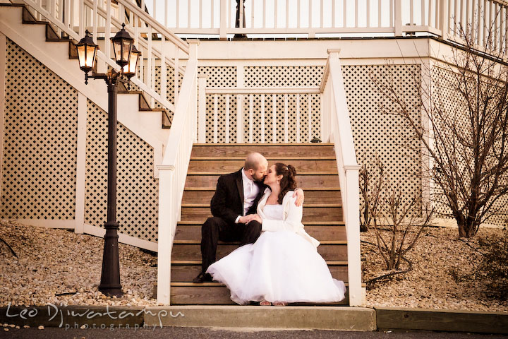 Bride and groom kissing on stair steps. Kitty Knight House Georgetown Chestertown MD Wedding Photographer