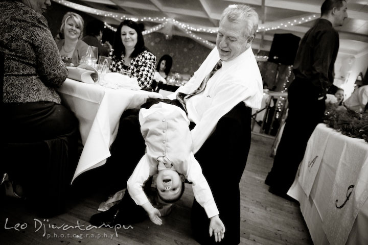 Grandfather playing with grandson, other guests looking. Kitty Knight House Georgetown Chestertown MD Wedding Photographer