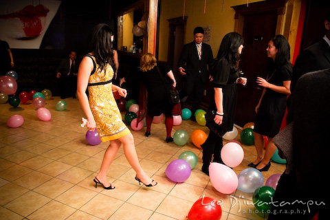 girl clearing balloons from dance floor