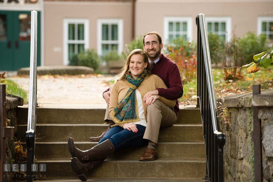 Engaged couple siting together and smiling for the camera. Annapolis Eastern Shore Maryland pre-wedding engagement photo session at downtown, by wedding photographers of Leo Dj Photography. http://leodjphoto.com