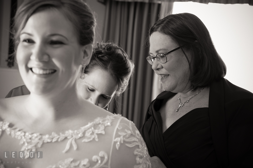 Mother and Matron of Honor helping Bride putting on the dress. The Tidewater Inn wedding, Easton, Eastern Shore, Maryland, by wedding photographers of Leo Dj Photography. http://leodjphoto.com