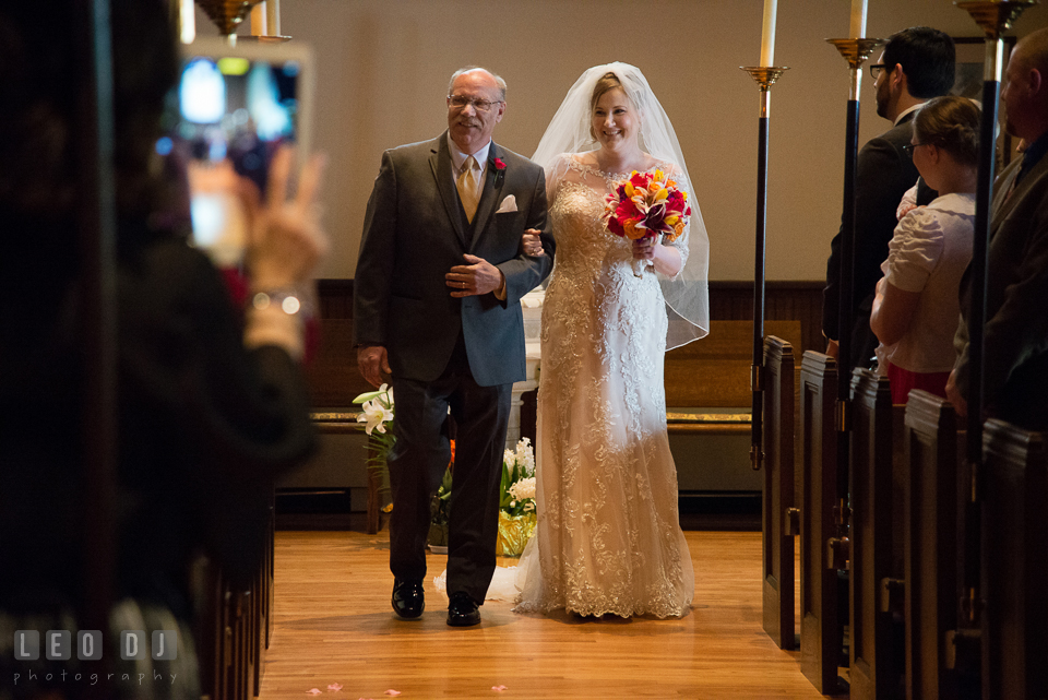 Bride walking down the aisle escorted by her Father. The Trinity Cathedral wedding, Easton, Eastern Shore, Maryland, by wedding photographers of Leo Dj Photography. http://leodjphoto.com