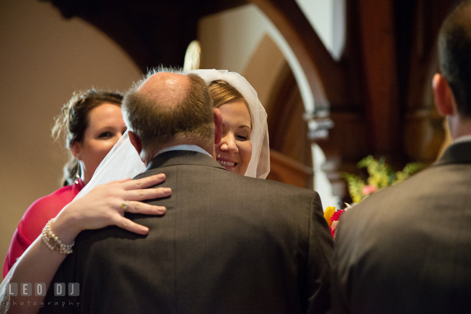 Bride hugging her Father as he was giving her away. The Trinity Cathedral wedding, Easton, Eastern Shore, Maryland, by wedding photographers of Leo Dj Photography. http://leodjphoto.com