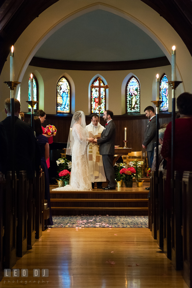 Bride and Groom holding hands during the ceremony. The Trinity Cathedral wedding, Easton, Eastern Shore, Maryland, by wedding photographers of Leo Dj Photography. http://leodjphoto.com