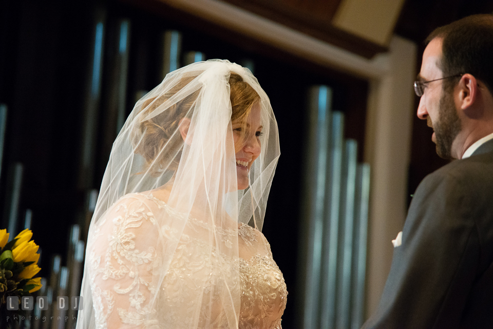 Bride smiling as she was listening to Groom reciting his vows. The Trinity Cathedral wedding, Easton, Eastern Shore, Maryland, by wedding photographers of Leo Dj Photography. http://leodjphoto.com