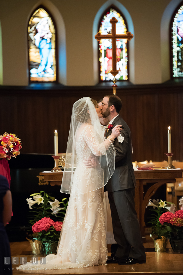 Bride and Groom kissing after officially pronounced as husband and wife. The Trinity Cathedral wedding, Easton, Eastern Shore, Maryland, by wedding photographers of Leo Dj Photography. http://leodjphoto.com