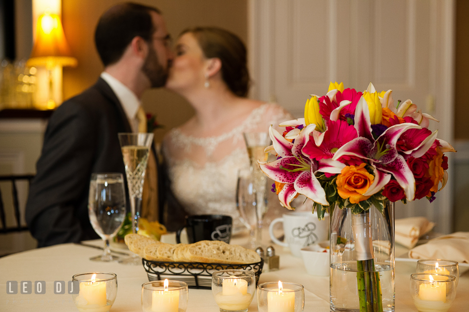 Bride and Groom kissing by the sweetheart table. The Tidewater Inn wedding, Easton, Eastern Shore, Maryland, by wedding photographers of Leo Dj Photography. http://leodjphoto.com