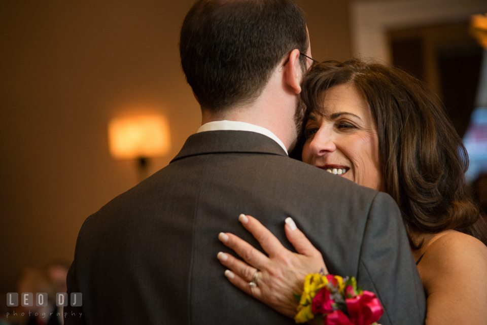 Mom smiling while hugging Groom during Mother-Son dance. The Tidewater Inn wedding, Easton, Eastern Shore, Maryland, by wedding photographers of Leo Dj Photography. http://leodjphoto.com