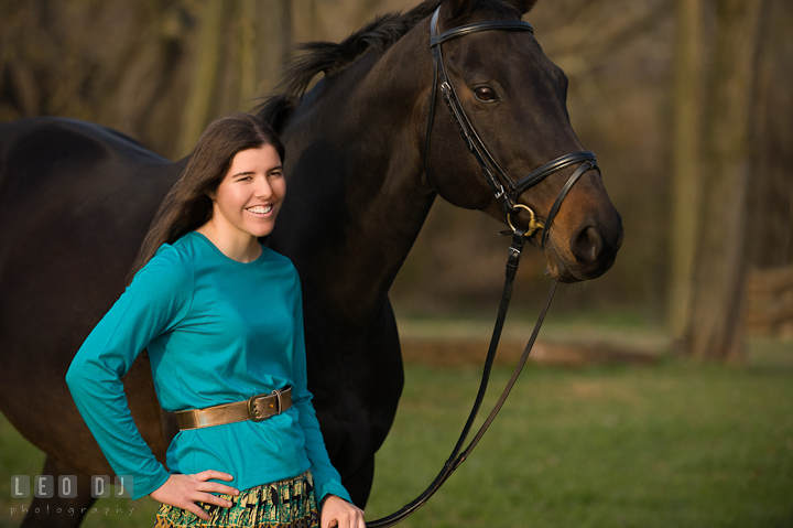 Girl smiling and posing with her horse. Montgomery County high school senior portrait session at Wyndham Oaks, Boyds, Maryland horse stables by photographer Leo Dj Photography. http://leodjphoto.com