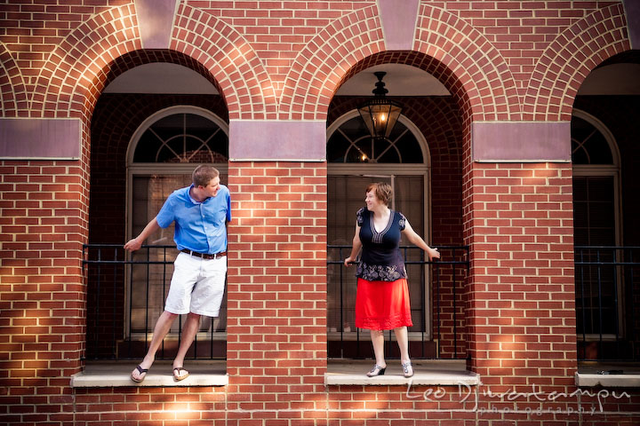 Engaged guy and girl looking at each other under the arches. Engagement Pre-wedding Photo Session Bel Air Maryland wedding photographer