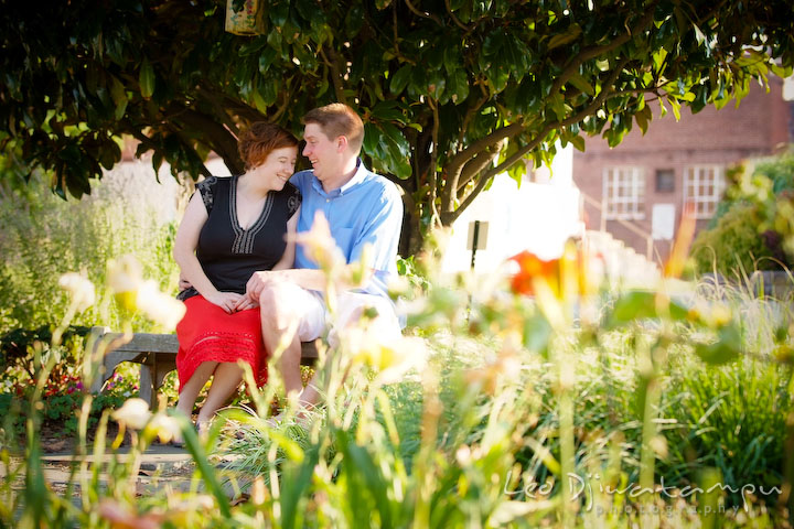 Engaged couple sitting under the tree, laughing. Engagement Pre-wedding Photo Session Bel Air Maryland wedding photographer