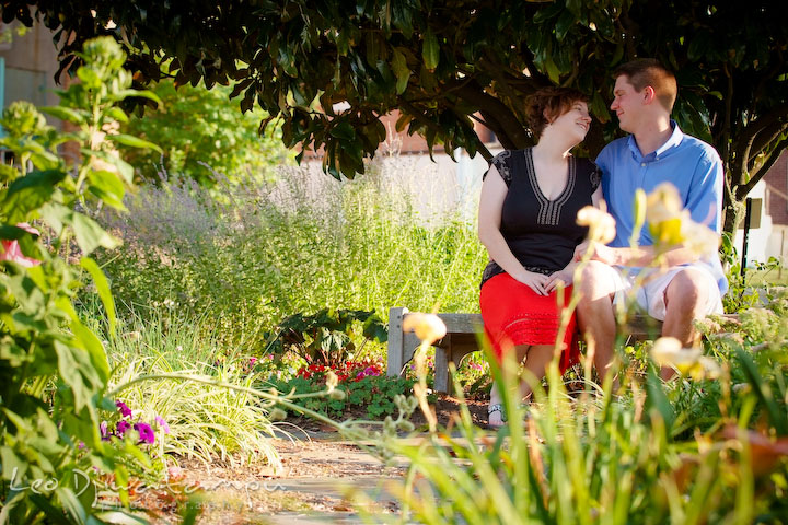 Engaged guy and girl sitting under a tree looking at each other and smiling. Engagement Pre-wedding Photo Session Bel Air Maryland wedding photographer