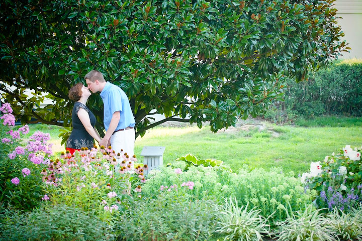 Engaged guy and girl kissing in a flower garden. Engagement Pre-wedding Photo Session Bel Air Maryland wedding photographer