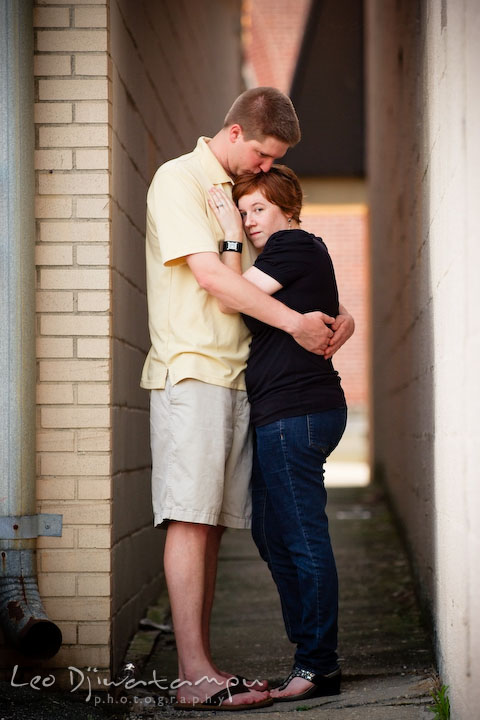 Engaged guy and girl hugging by an alley. Engagement Pre-wedding Photo Session Bel Air Maryland wedding photographer