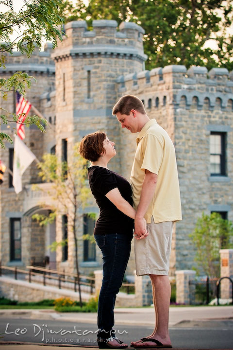 Engaged couple holding hands, looking at each other. Brick castle in the background. Engagement Pre-wedding Photo Session Bel Air Maryland wedding photographer