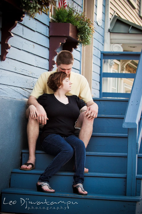 Engaged girl sitting on stairs in front of her fiancee. Engagement Pre-wedding Photo Session Bel Air Maryland wedding photographer