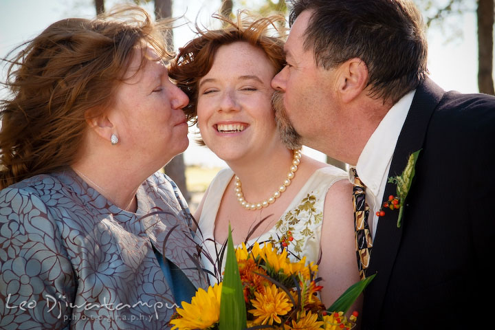 Mom and dad kissed bride. Rock Hall, Chestertown, Kingstown, and Georgetown Maryland wedding photographer, Leo Dj Photography