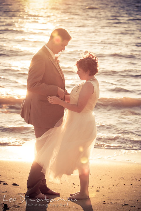 Bride and groom holding each other on the beach. Rock Hall, Chestertown, Kingstown, and Georgetown Maryland wedding photographer, Leo Dj Photography