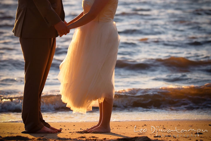 Bride and groom holding hands, standing on beach sand. Rock Hall, Chestertown, Kingstown, and Georgetown Maryland wedding photographer, Leo Dj Photography