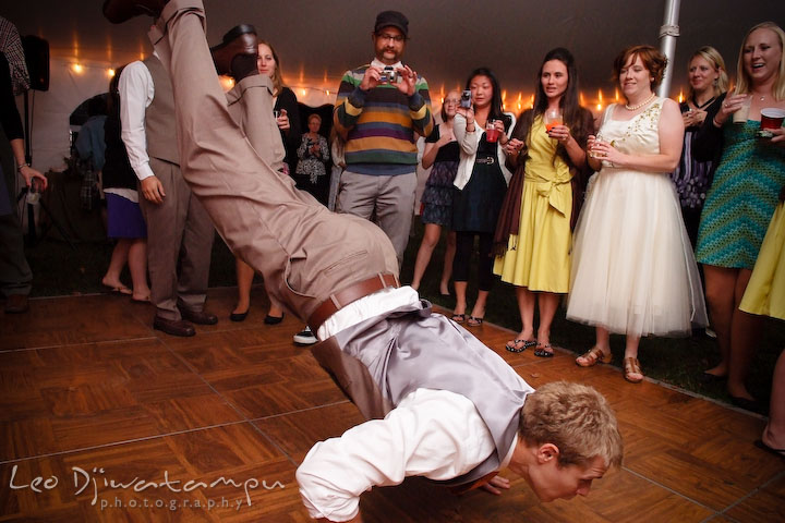 A guy guest doing a breakdance on the floor. Rock Hall, Chestertown, Kingstown, and Georgetown Maryland wedding photographer, Leo Dj Photography