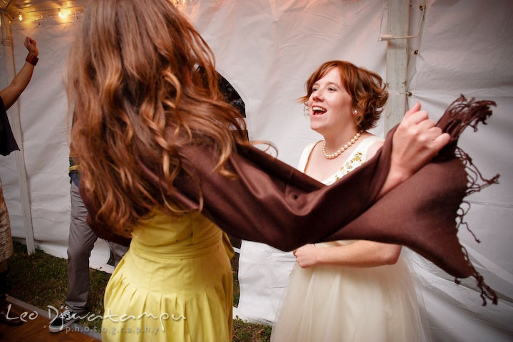 Maid of honor flipping her scarf in the air while dancing with bride. Rock Hall, Chestertown, Kingstown, and Georgetown Maryland wedding photographer, Leo Dj Photography