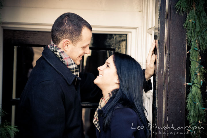 engaged couple looking at each other, laughing. Urban City Pre-wedding Engagement Photographer Annapolis MD
