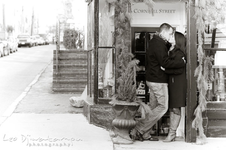 guy and girl kissing in front of a store. Urban City Pre-wedding Engagement Photographer Annapolis MD