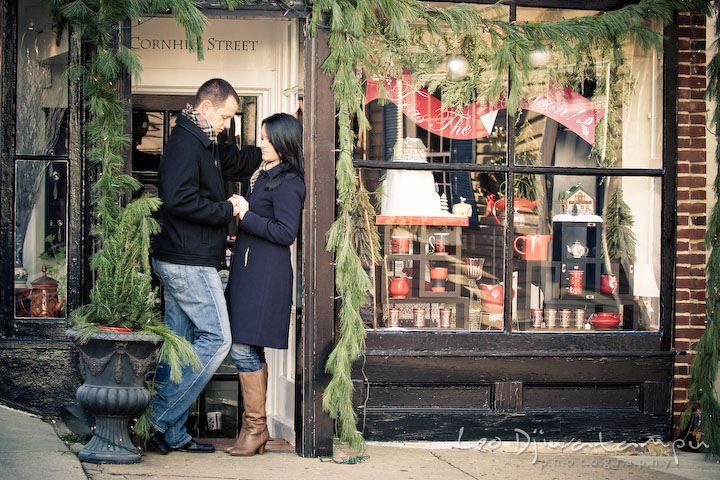 engaged couple holding hands, looking at engagement ring. Urban City Pre-wedding Engagement Photographer Annapolis MD