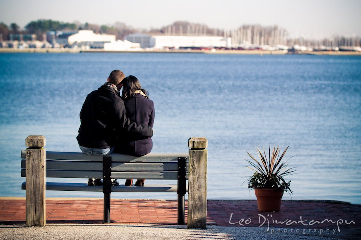 engaged couple sitting overlooking at the US Naval Academy USNA. Urban City Pre-wedding Engagement Photographer Annapolis Eastport MD