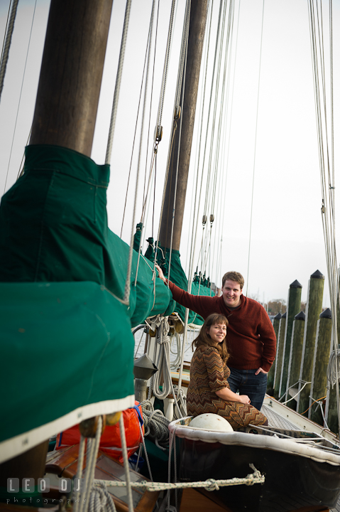 Engaged couple posing on the sailboat. Pre-wedding engagement photo session at Annapolis, Eastport, Maryland, Quiet Waters Park, by wedding photographers of Leo Dj Photography. http://leodjphoto.com