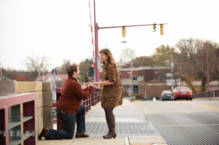 Guy proposing to his girl on the bridge. Pre-wedding engagement photo session at Annapolis, Eastport, Maryland, Quiet Waters Park, by wedding photographers of Leo Dj Photography. http://leodjphoto.com