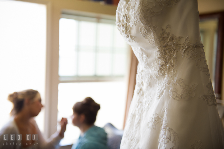 Detail of Bride's wedding gown with Bride getting make up in the background. Kent Island Maryland Matapeake Beach wedding ceremony and getting ready photo, by wedding photographers of Leo Dj Photography. http://leodjphoto.com