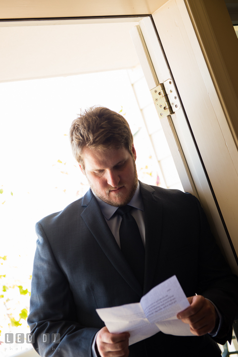 Groom reading letter. Kent Island Maryland Matapeake Beach wedding ceremony and getting ready photo, by wedding photographers of Leo Dj Photography. http://leodjphoto.com