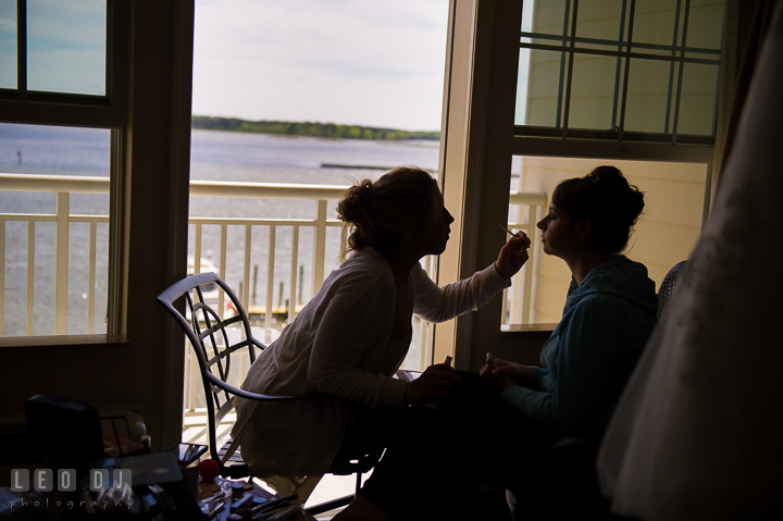 Silhouette of Bride getting make up done in hotel room of Hilton Garden Inn with beautiful waterfront view from balcony. Kent Island Maryland Matapeake Beach wedding ceremony and getting ready photo, by wedding photographers of Leo Dj Photography. http://leodjphoto.com