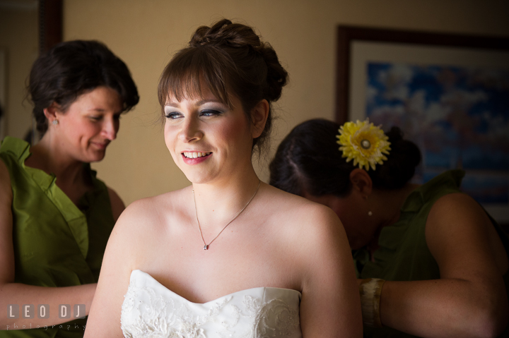 Bridesmaid and Maid of Honor help putting on wedding dress on Bride. Kent Island Maryland Matapeake Beach wedding ceremony and getting ready photo, by wedding photographers of Leo Dj Photography. http://leodjphoto.com