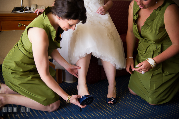 Bridesmaid and Maid of Honor help putting shoes on Bride. Kent Island Maryland Matapeake Beach wedding ceremony and getting ready photo, by wedding photographers of Leo Dj Photography. http://leodjphoto.com