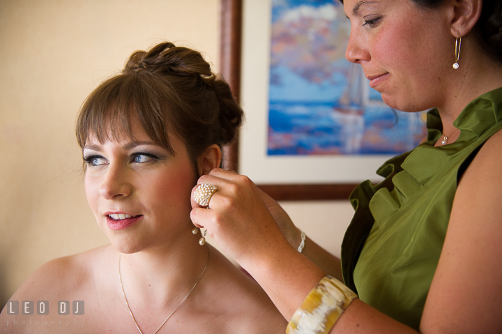 Maid of Honor help putting on earrings on Bride. Kent Island Maryland Matapeake Beach wedding ceremony and getting ready photo, by wedding photographers of Leo Dj Photography. http://leodjphoto.com