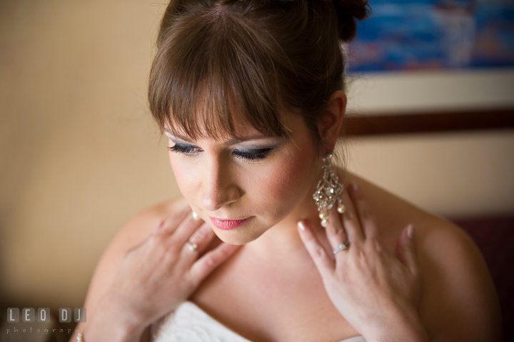 Bride showing her earrings. Kent Island Maryland Matapeake Beach wedding ceremony and getting ready photo, by wedding photographers of Leo Dj Photography. http://leodjphoto.com