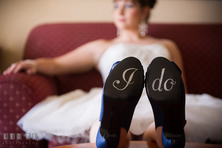 Bride sitting on couch showing her shoe soles with I do writing. Kent Island Maryland Matapeake Beach wedding ceremony and getting ready photo, by wedding photographers of Leo Dj Photography. http://leodjphoto.com