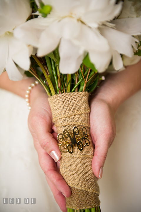 Bride holding her floral bouquet with heirloom pin from Grandmother on burlap. Kent Island Maryland Matapeake Beach wedding ceremony and getting ready photo, by wedding photographers of Leo Dj Photography. http://leodjphoto.com