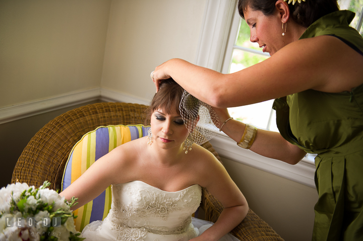 Maid of Honor help putting on veil on bride. Kent Island Maryland Matapeake Beach wedding ceremony and getting ready photo, by wedding photographers of Leo Dj Photography. http://leodjphoto.com