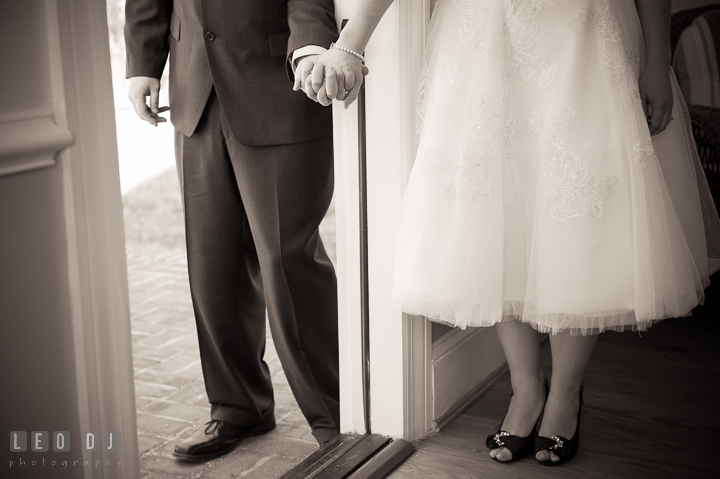 Bride and groom not seeing each other but holding hands by door. Kent Island Maryland Matapeake Beach wedding ceremony and getting ready photo, by wedding photographers of Leo Dj Photography. http://leodjphoto.com