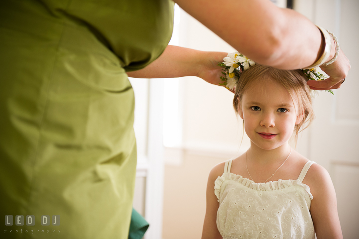 Maid of Honor put daisy flower crown on flower girl's head. Kent Island Maryland Matapeake Beach wedding ceremony and getting ready photo, by wedding photographers of Leo Dj Photography. http://leodjphoto.com