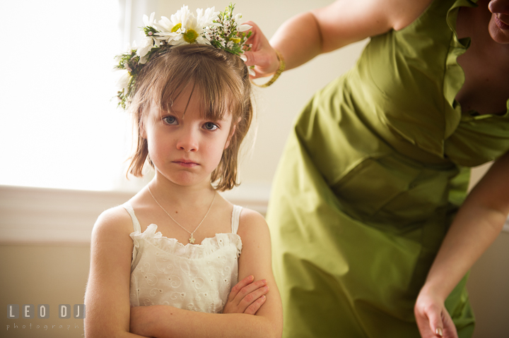 Bridesmaid put on crown of white flower on flower girl's head. Kent Island Maryland Matapeake Beach wedding ceremony and getting ready photo, by wedding photographers of Leo Dj Photography. http://leodjphoto.com