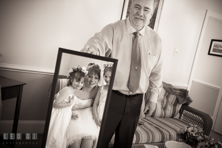 Father of Bride holding a mirror for Bride and flower girls to see themselves. Kent Island Maryland Matapeake Beach wedding ceremony and getting ready photo, by wedding photographers of Leo Dj Photography. http://leodjphoto.com