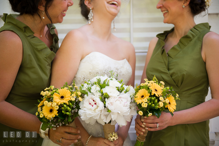 Maid of Honor, Bride and Bridesmaid laughing and showing their yellow and white flower bouquets. Kent Island Maryland Matapeake Beach wedding ceremony and getting ready photo, by wedding photographers of Leo Dj Photography. http://leodjphoto.com