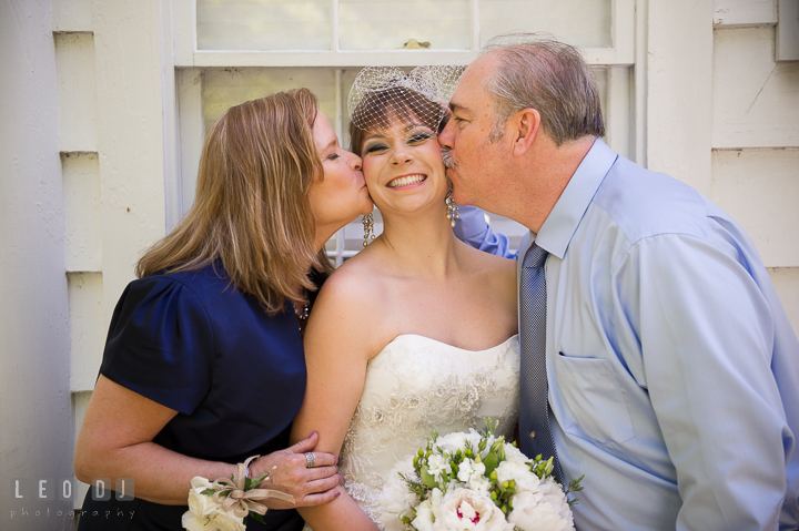 Mother and Father of Bride kissing their daughter. Kent Island Maryland Matapeake Beach wedding ceremony and getting ready photo, by wedding photographers of Leo Dj Photography. http://leodjphoto.com